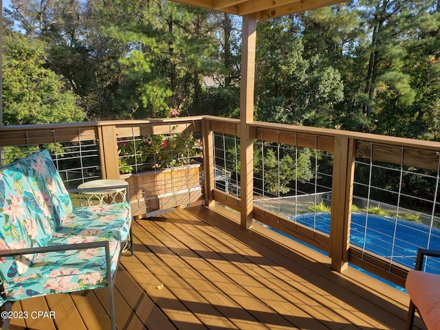 wooden terrace featuring tennis court