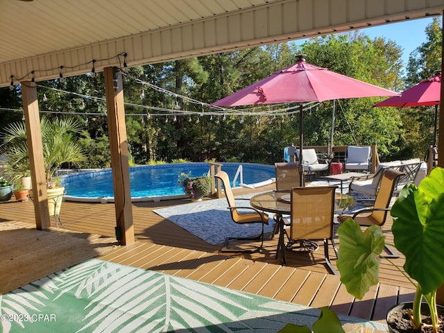 view of swimming pool with a deck