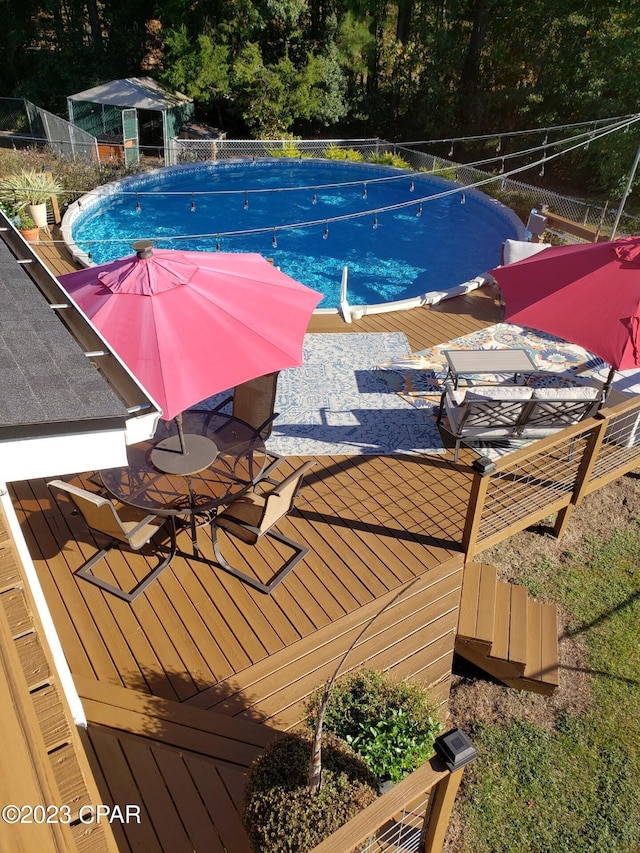 view of swimming pool with a deck