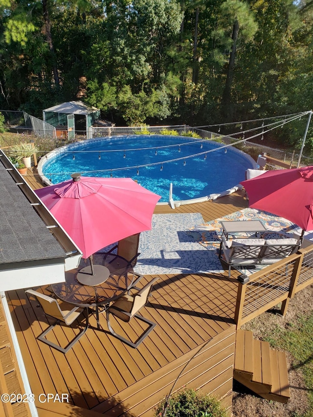 view of pool with a wooden deck