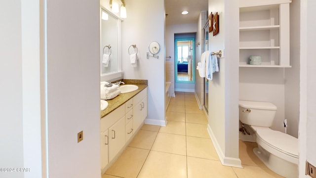 bathroom featuring toilet, vanity, and tile patterned flooring