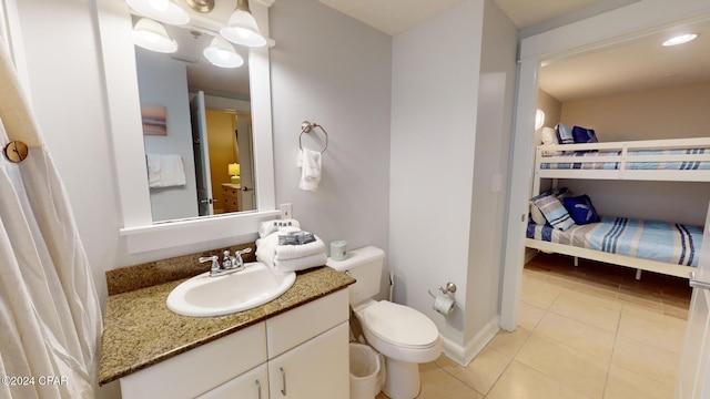 bathroom with vanity, tile patterned floors, and toilet