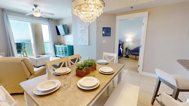 dining space featuring light tile patterned floors and ceiling fan with notable chandelier