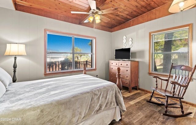 bedroom with ceiling fan, dark hardwood / wood-style flooring, wood ceiling, and multiple windows