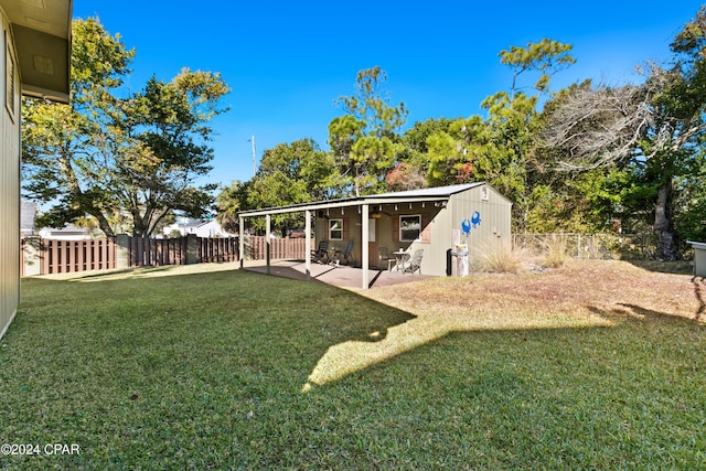 view of yard with a storage shed and a patio