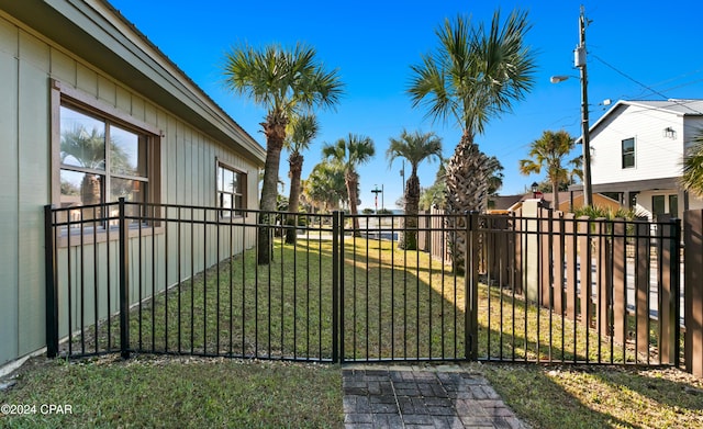 view of gate featuring a yard