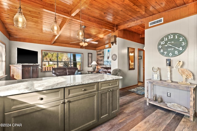 kitchen with wood ceiling, light stone countertops, pendant lighting, and dark hardwood / wood-style floors