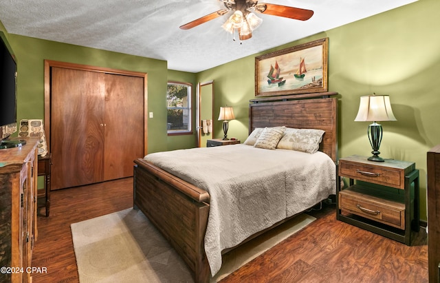 bedroom featuring a textured ceiling, a closet, dark hardwood / wood-style floors, and ceiling fan