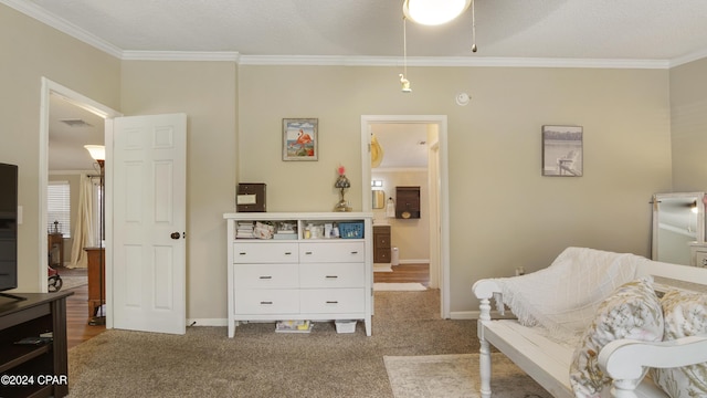 sitting room with crown molding and carpet flooring