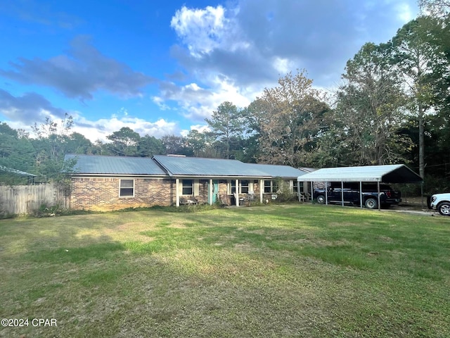 ranch-style home featuring a carport and a front yard