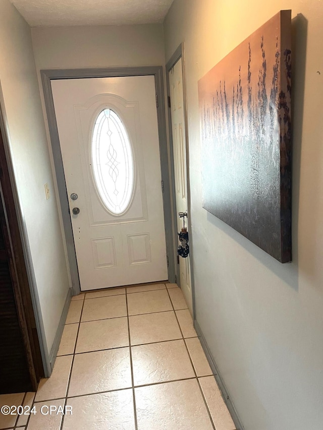 entryway with light tile patterned floors