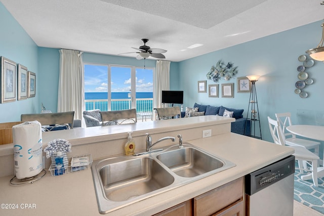 kitchen featuring ceiling fan, dishwasher, sink, and a textured ceiling