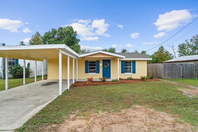 view of front of property with a front lawn and a carport