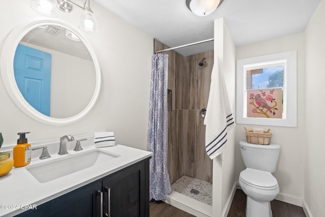 bathroom featuring a shower with curtain, hardwood / wood-style flooring, vanity, and toilet