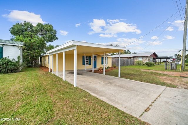 view of front of property with a front yard and a carport