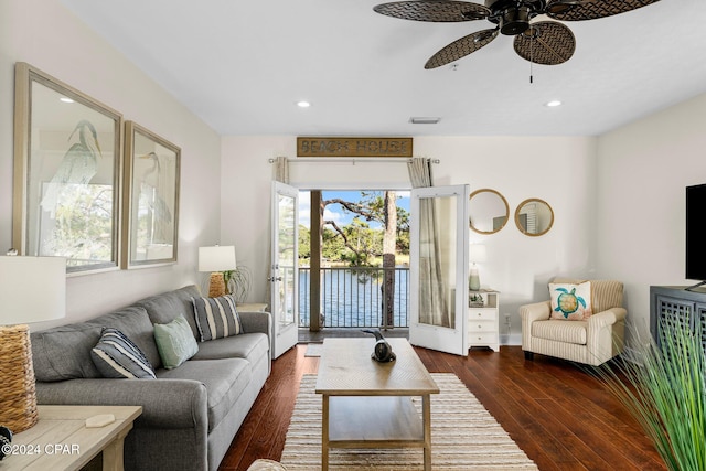 living room with ceiling fan and dark hardwood / wood-style flooring