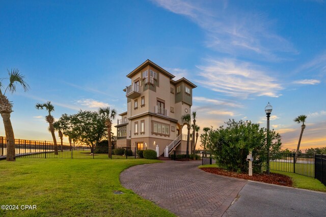 exterior space featuring a balcony and a yard