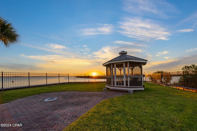 exterior space featuring a patio area, a water view, and a gazebo