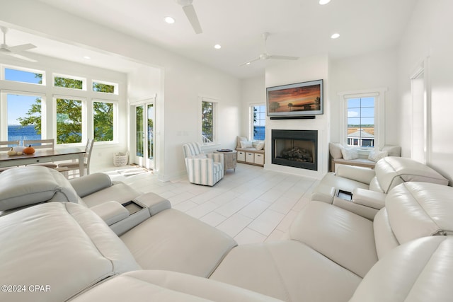 living room with a water view and ceiling fan