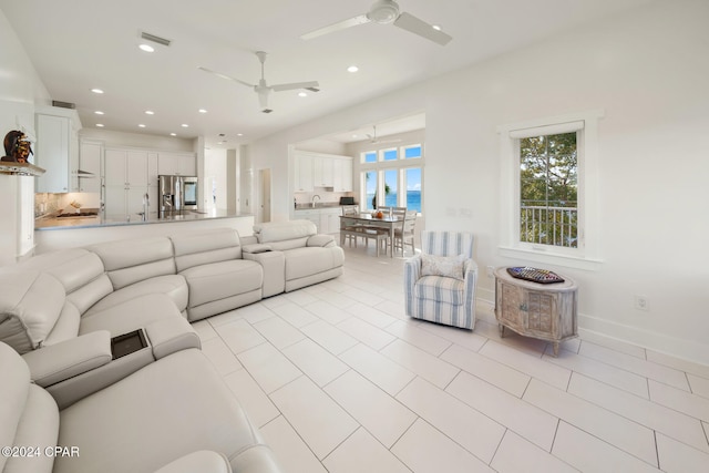 tiled living room with ceiling fan