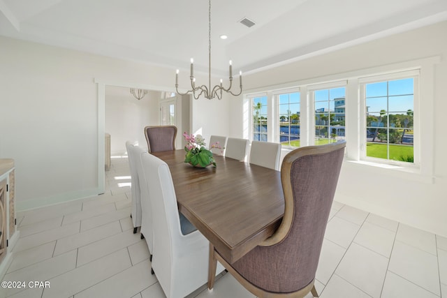 dining space with a notable chandelier and light tile patterned floors