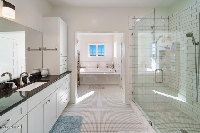 bathroom featuring tile patterned flooring, vanity, and plus walk in shower