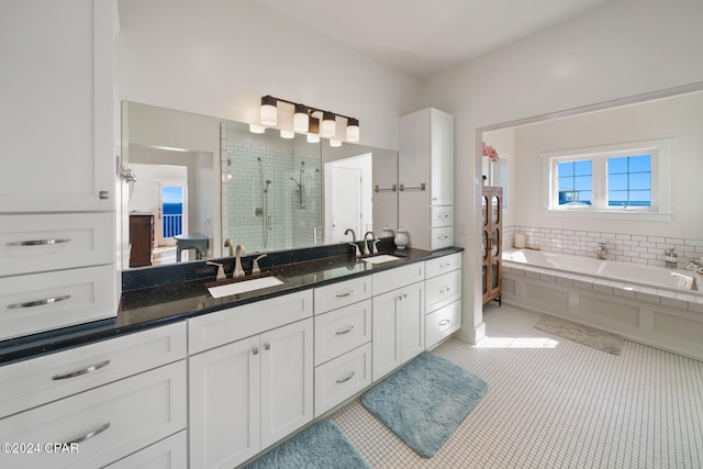 bathroom featuring vanity, tile patterned flooring, and shower with separate bathtub