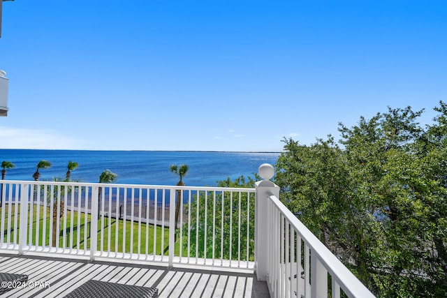 balcony featuring a view of the beach and a water view