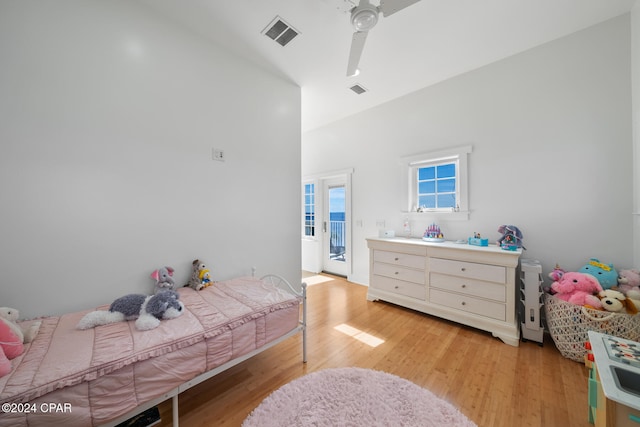 bedroom with a high ceiling, light hardwood / wood-style floors, and ceiling fan