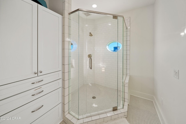 bathroom with walk in shower and tile patterned floors