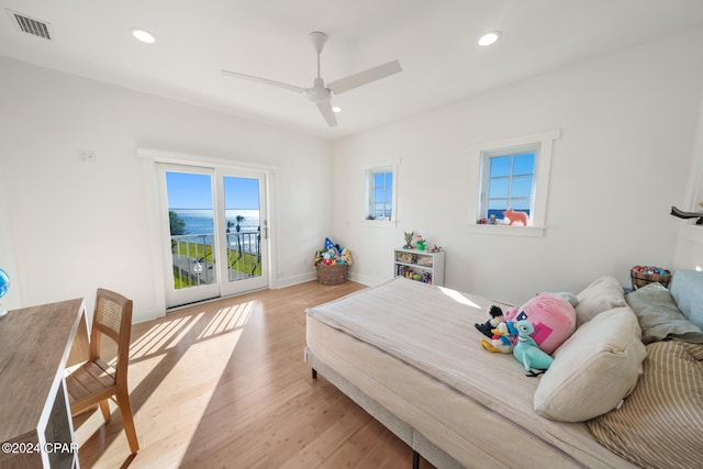 bedroom featuring access to outside, ceiling fan, and light wood-type flooring