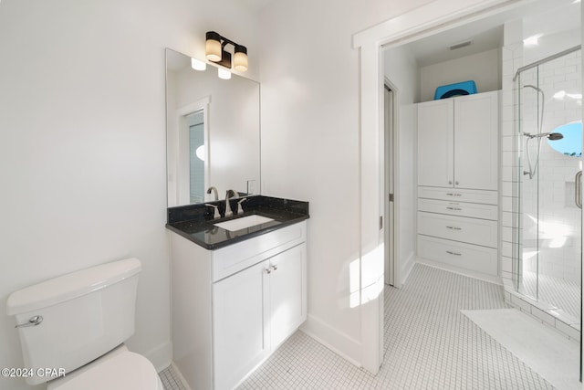 bathroom with toilet, an enclosed shower, vanity, and tile patterned floors