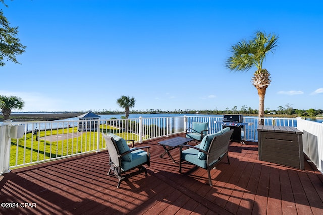 deck featuring a water view, area for grilling, and a yard