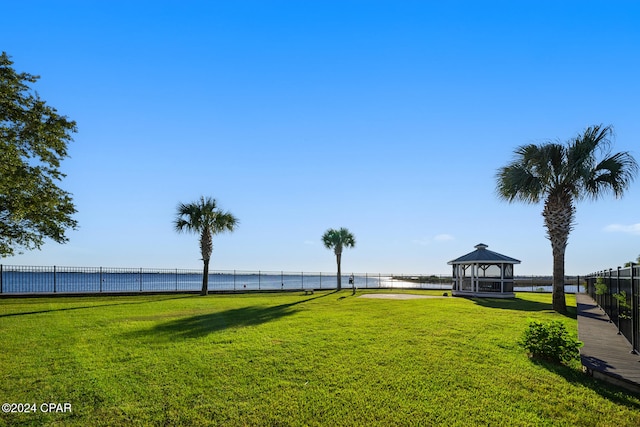 view of yard featuring a water view and a gazebo