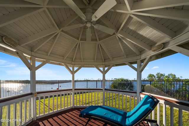 deck featuring a water view, a lawn, and a gazebo