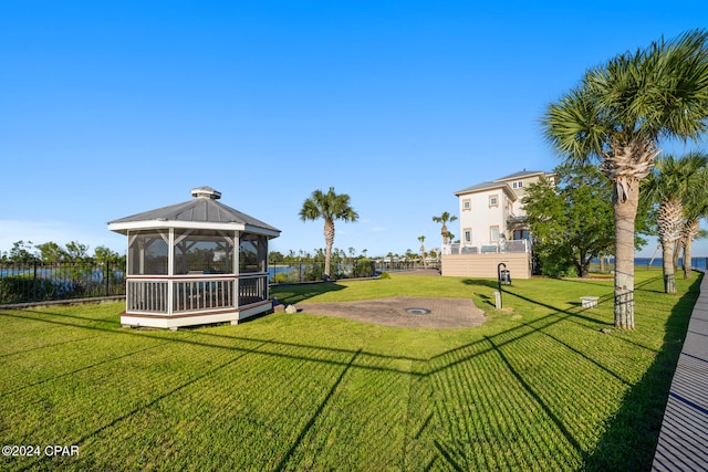 view of yard featuring a sunroom and a gazebo