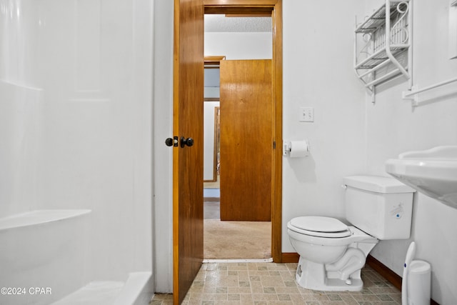 bathroom with toilet and a shower