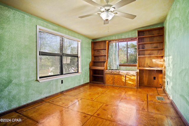 spare room with lofted ceiling, ceiling fan, and plenty of natural light