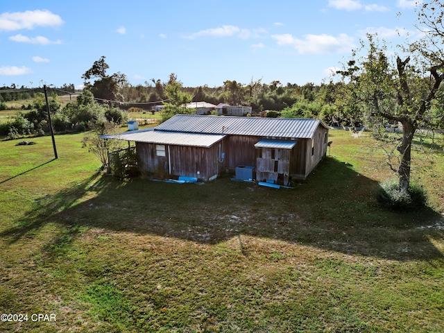 exterior space with a rural view and a yard