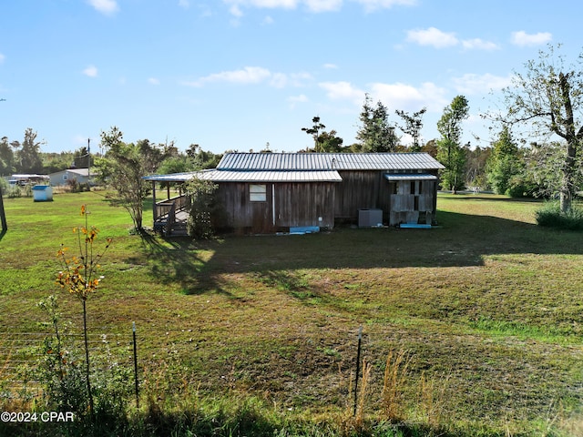 view of yard with central AC and an outdoor structure