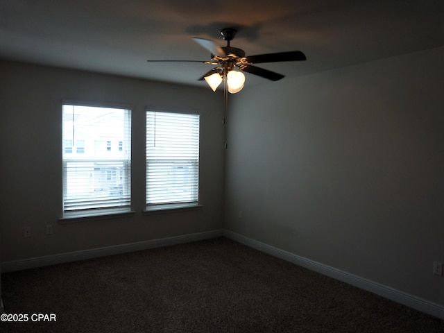 empty room with carpet floors, a healthy amount of sunlight, and ceiling fan