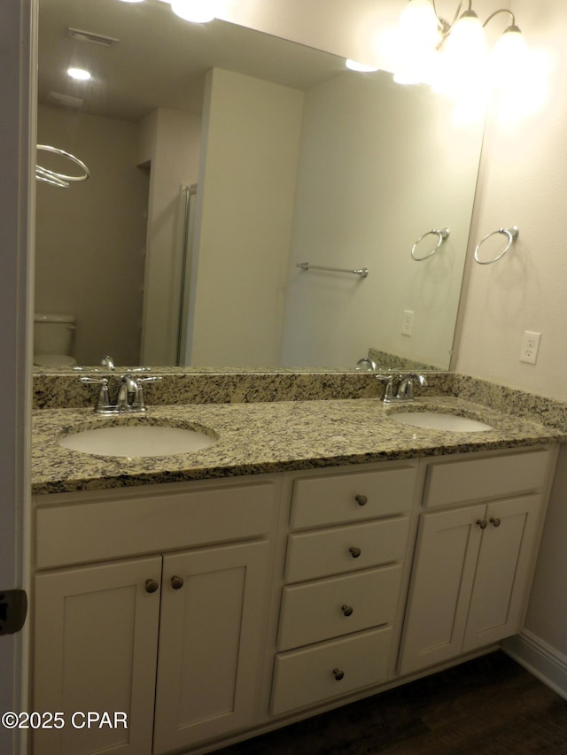 bathroom with vanity, hardwood / wood-style flooring, and toilet