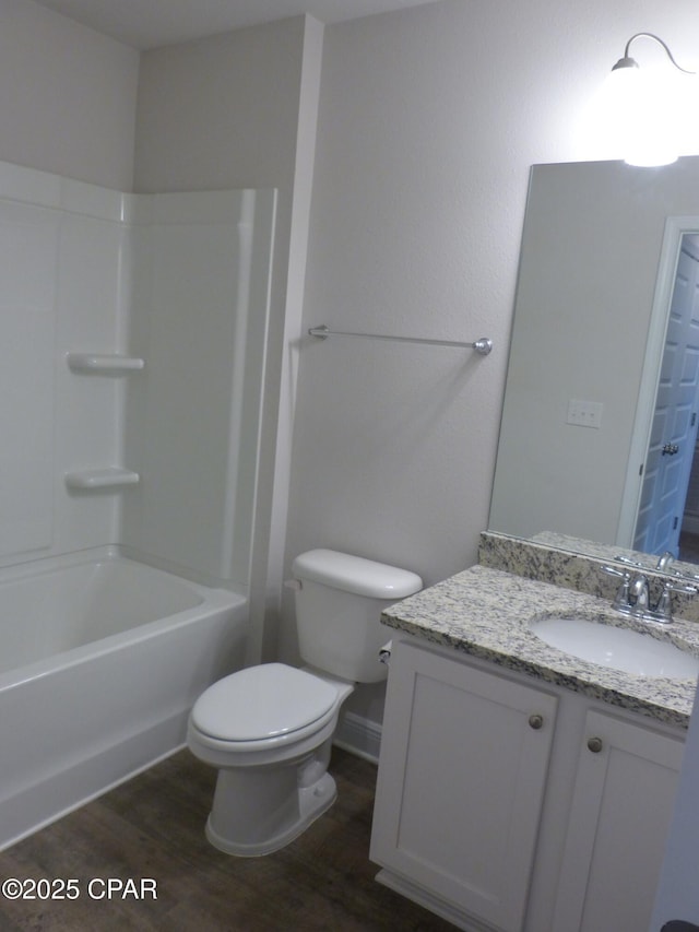 full bathroom featuring hardwood / wood-style flooring, shower / tub combination, vanity, and toilet