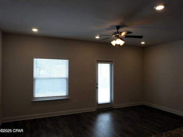 spare room featuring dark hardwood / wood-style floors and ceiling fan