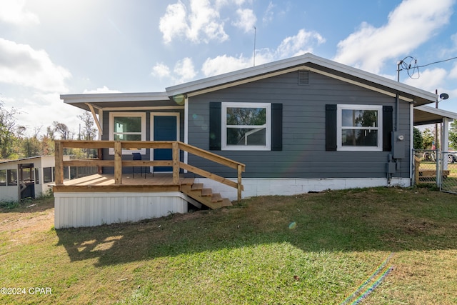 view of front of home with a wooden deck and a front lawn