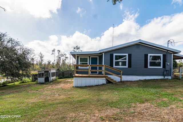 rear view of property with a yard