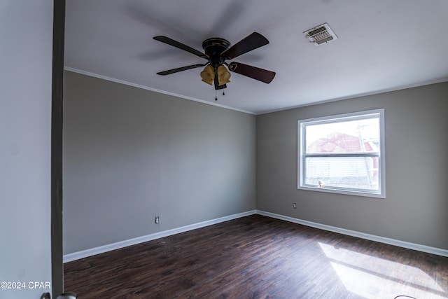 empty room featuring dark wood-type flooring, ceiling fan, and crown molding