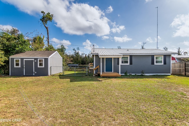 back of property with a yard and a storage shed