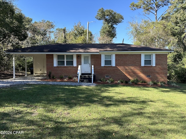 ranch-style home with a carport, brick siding, crawl space, and a front lawn