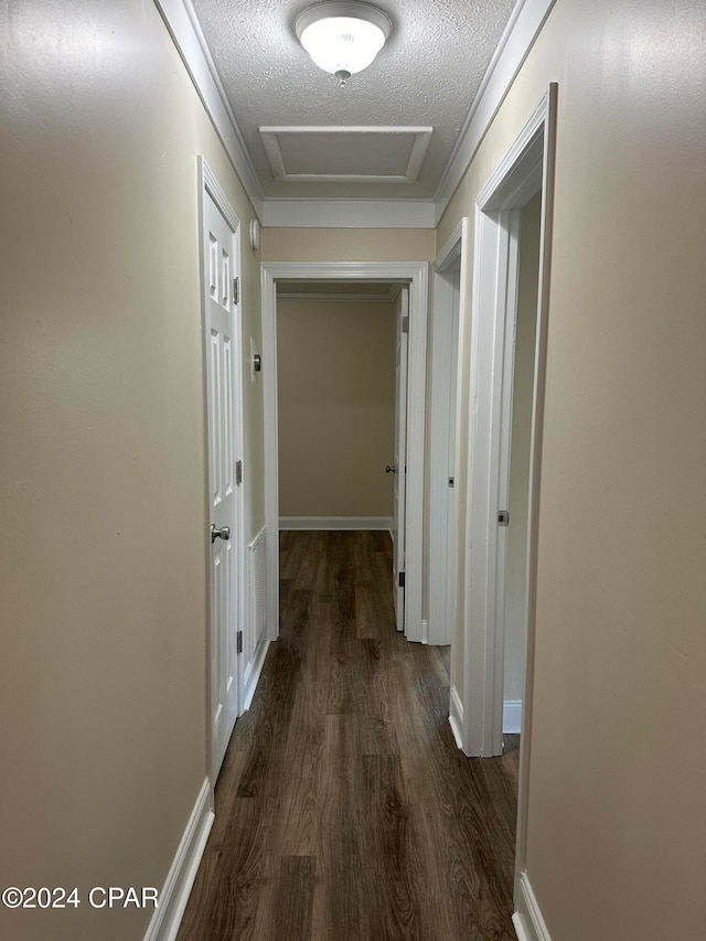 hall with dark hardwood / wood-style flooring and a textured ceiling